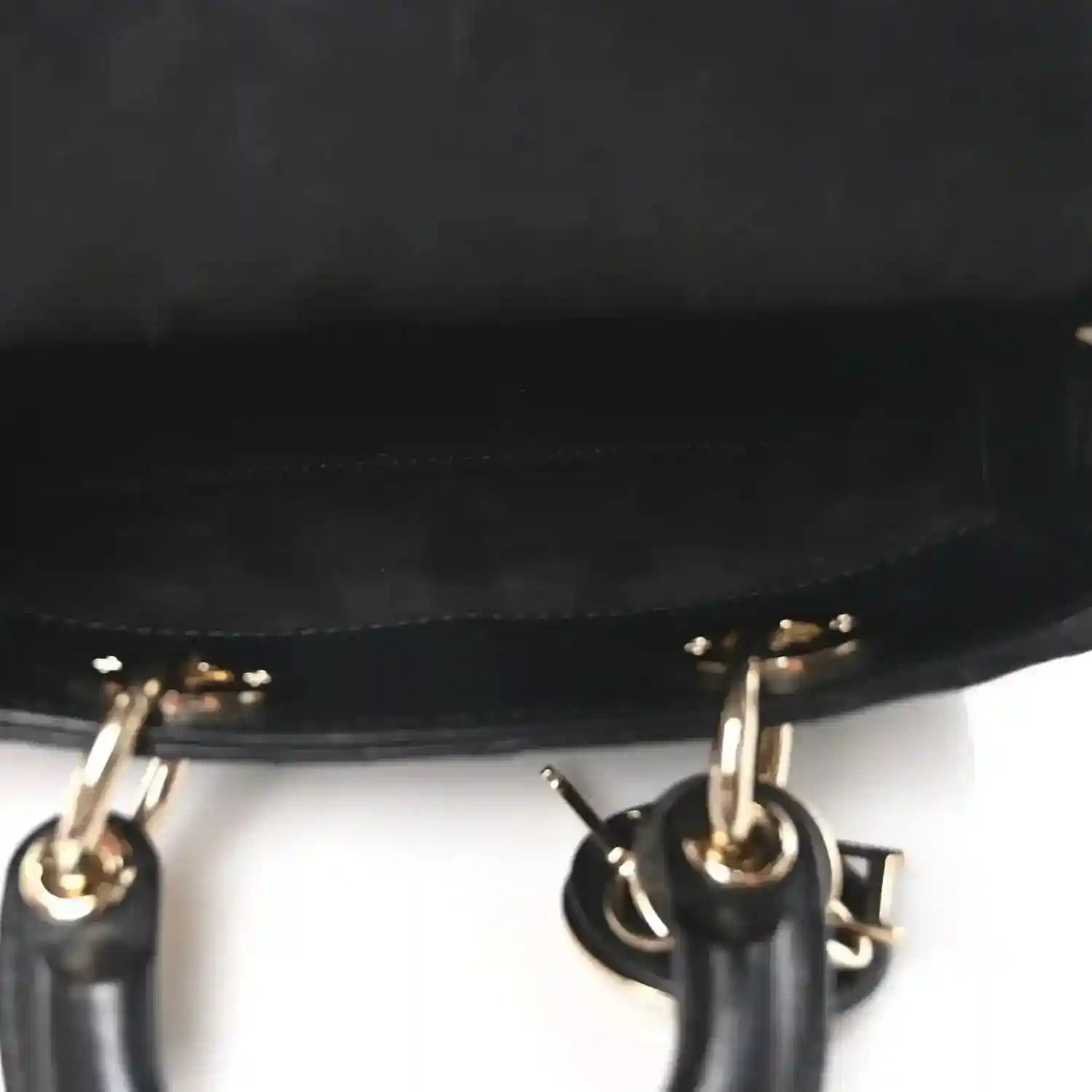 Black handbag chain strap with gold-tone rings and hardware close-up