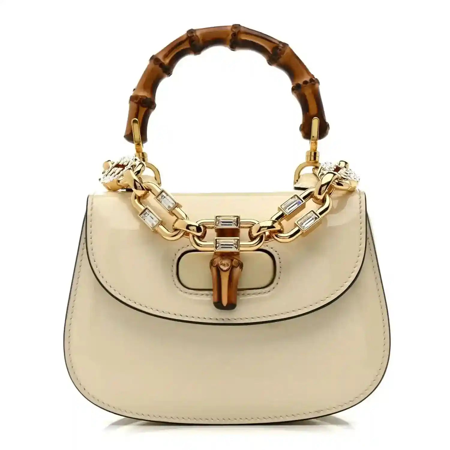 White mini handbag with bamboo-style handle and gold chain strap, top clasp