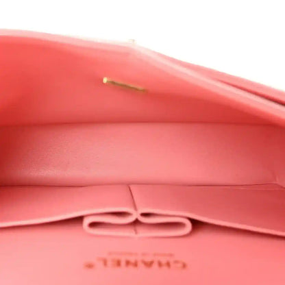 Light pink quilted interior with bow-like snap detail and CHANEL stamp