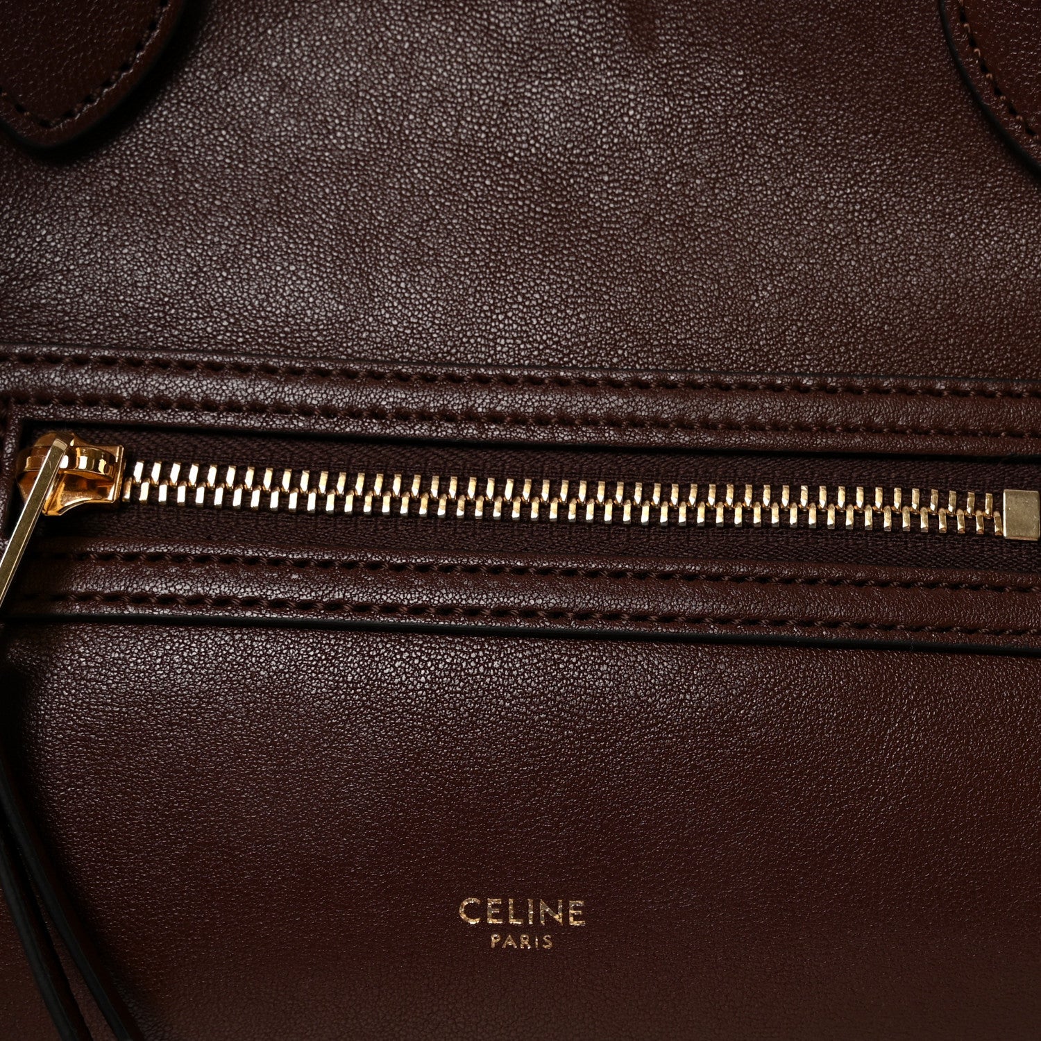 Celine lambskin handbag front zipper with gold-toned pull and stitched leather edge