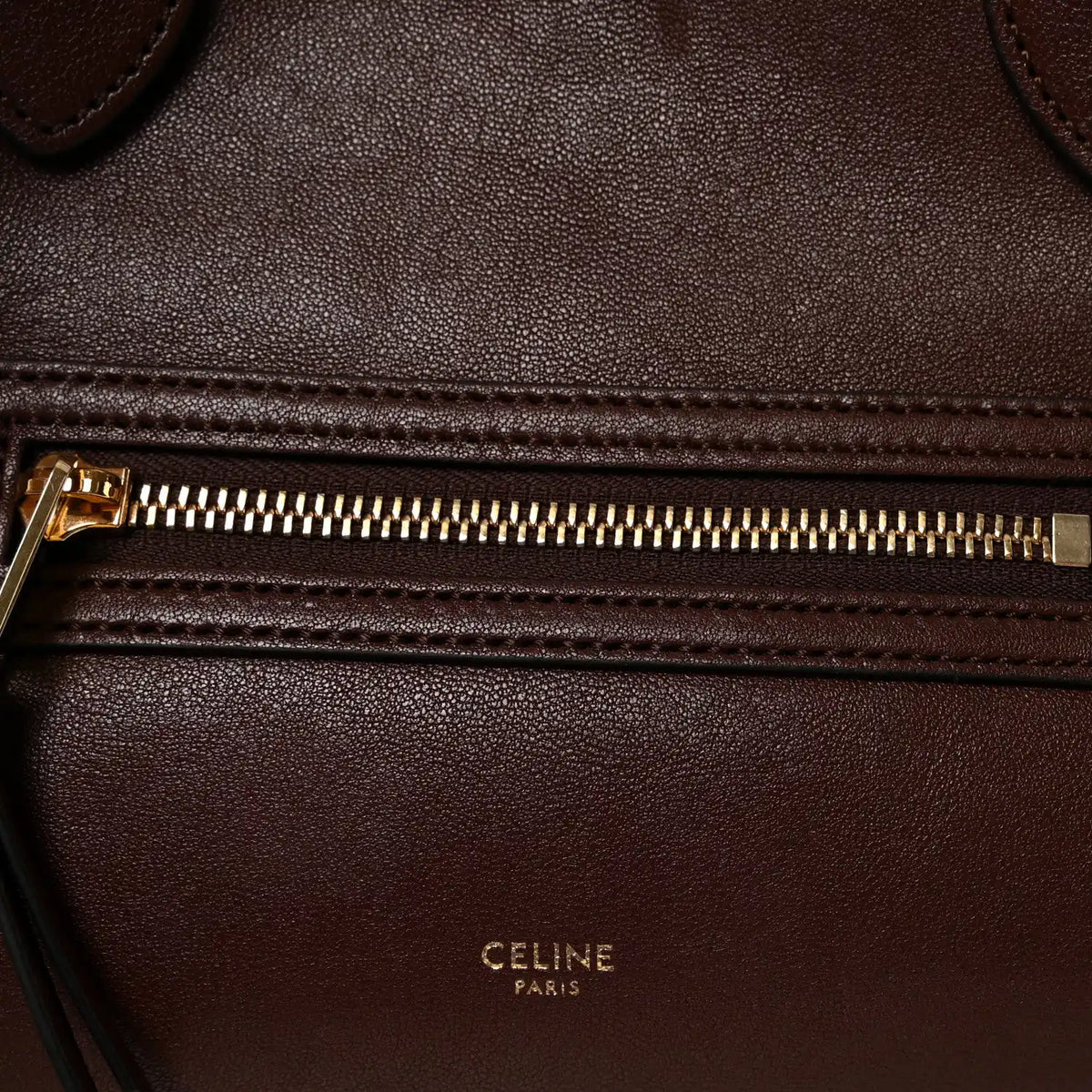 Celine lambskin handbag front zipper with gold-toned pull and stitched leather edge