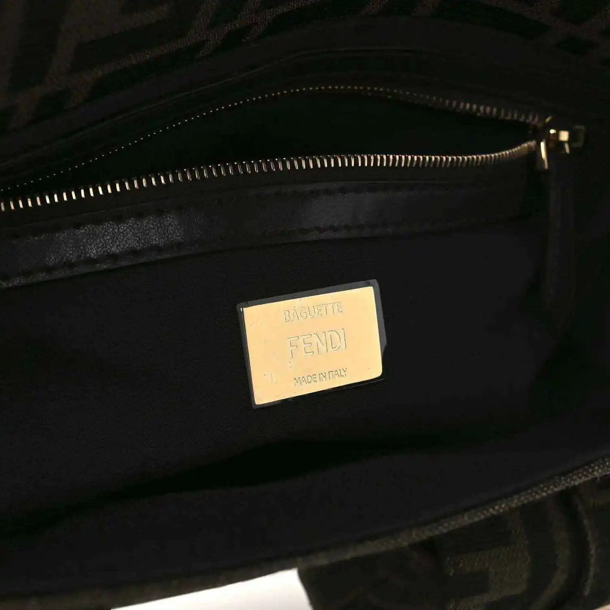 Fendi baguette bag interior with Fendi label and zippered lining, dark jacquard fabric