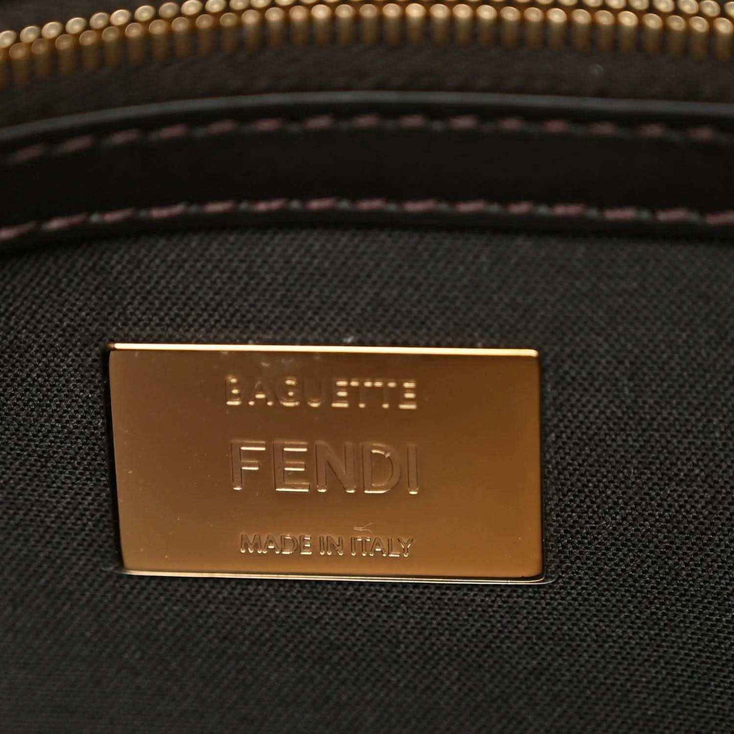 Fendi baguette bag brand plaque with 'FENDI' text in gold tone