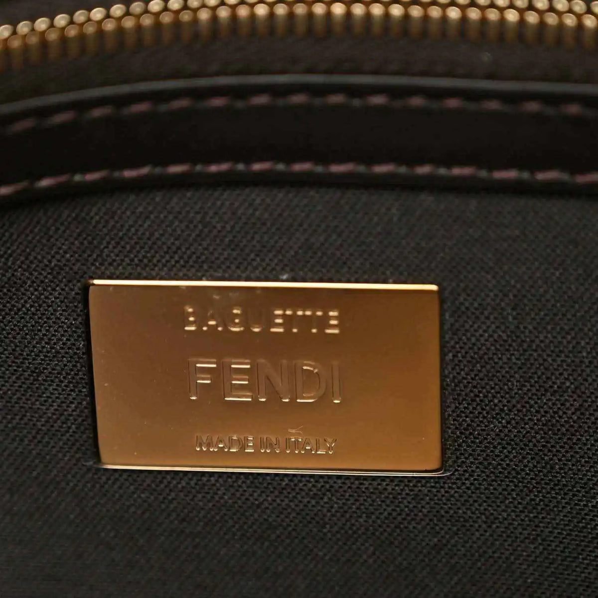 Fendi baguette bag brand plaque with 'FENDI' text in gold tone