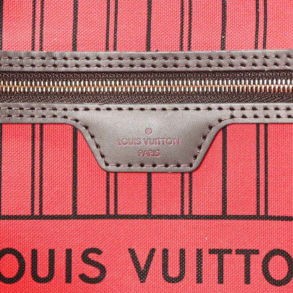 Tote bag leather logo patch and stitching on red striped lining panel