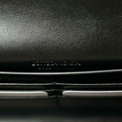Black leather clutch exterior with embossed Bottega Veneta logo