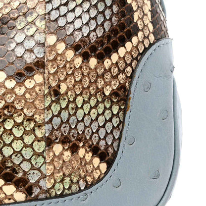 Hobo bag close-up: snakeskin pattern with light blue leather side trim