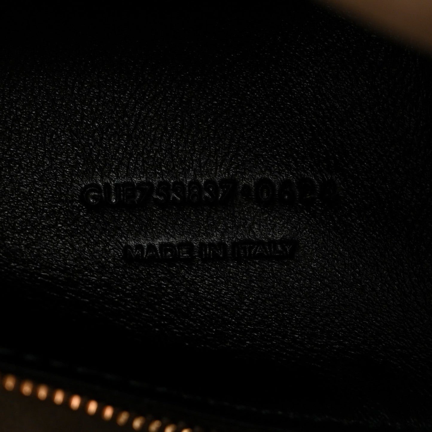 Saint Laurent embossed branding on smooth leather surface, made in Italy