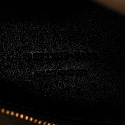 Saint Laurent embossed branding on smooth leather surface, made in Italy
