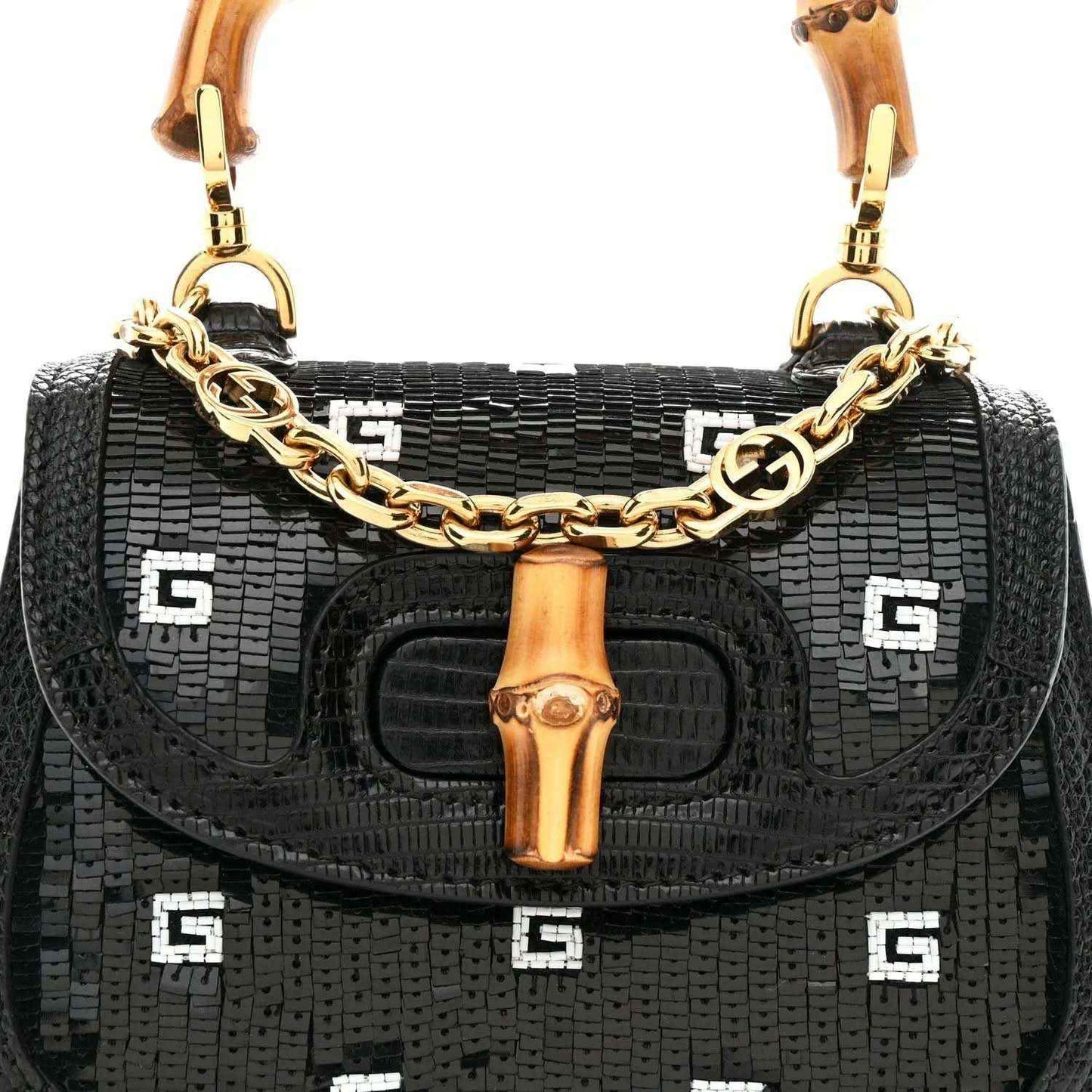 Black mini shoulder bag front view with gold chain strap, bamboo handle, and logo pattern