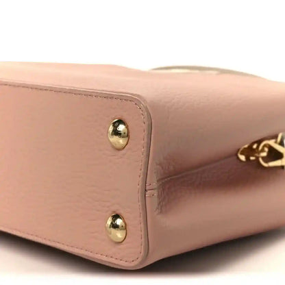 Rose leather handbag corner with gold stud hardware and LV charm detail