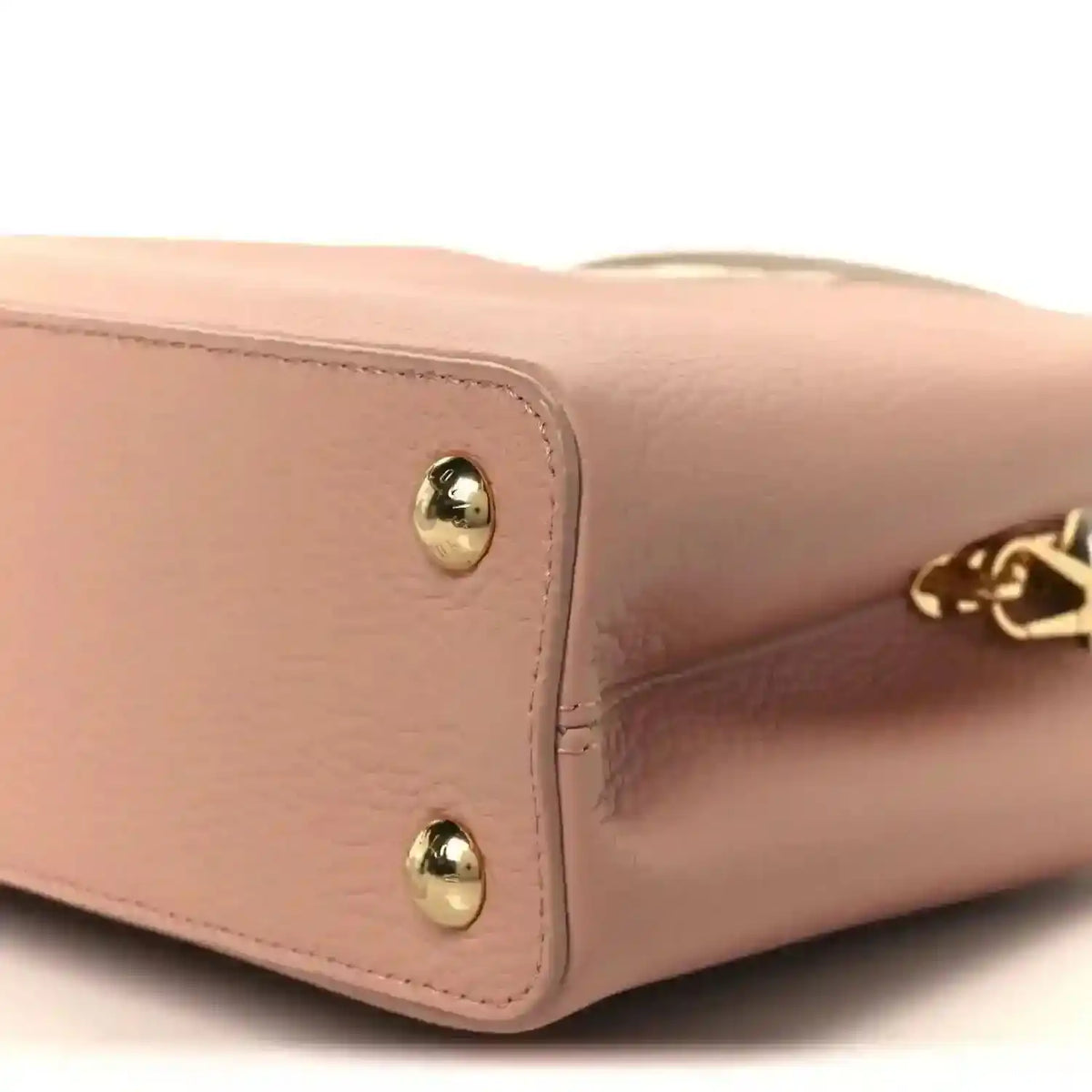 Rose leather handbag corner with gold stud hardware and LV charm detail