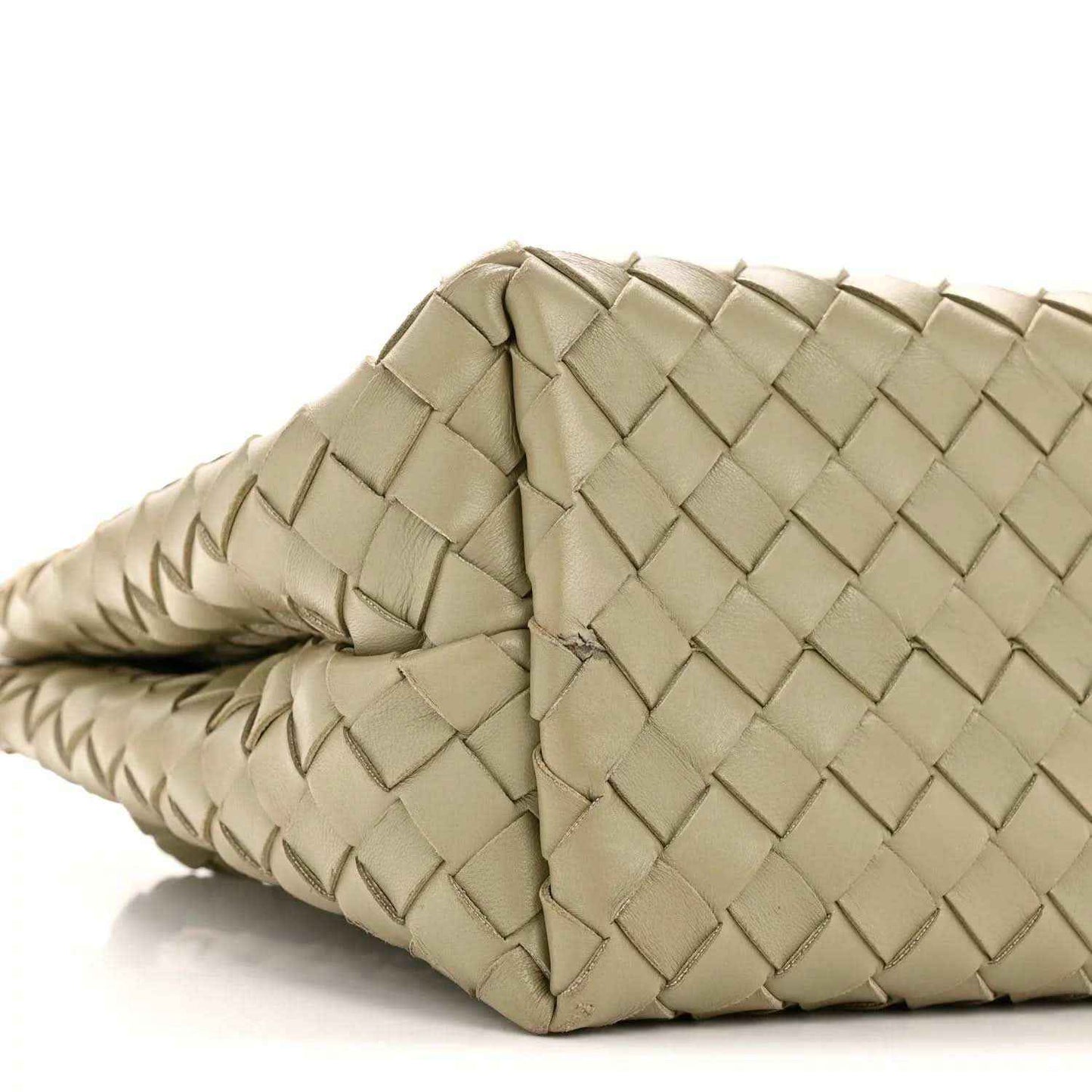 Woven leather tote corner with braided strap detail, light tan