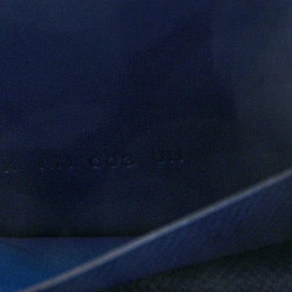 Blue leather slim wallet close-up with faint embossed mark