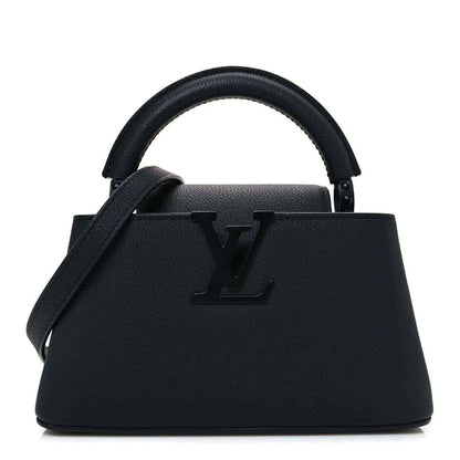 Louis Vuitton mini handbag in matte black leather with top handles and LV emblem.