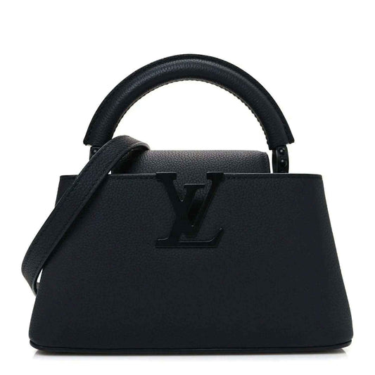 Louis Vuitton mini handbag in matte black leather with top handles and LV emblem.