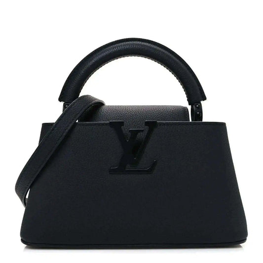 Louis Vuitton mini handbag in matte black leather with top handles and LV emblem.