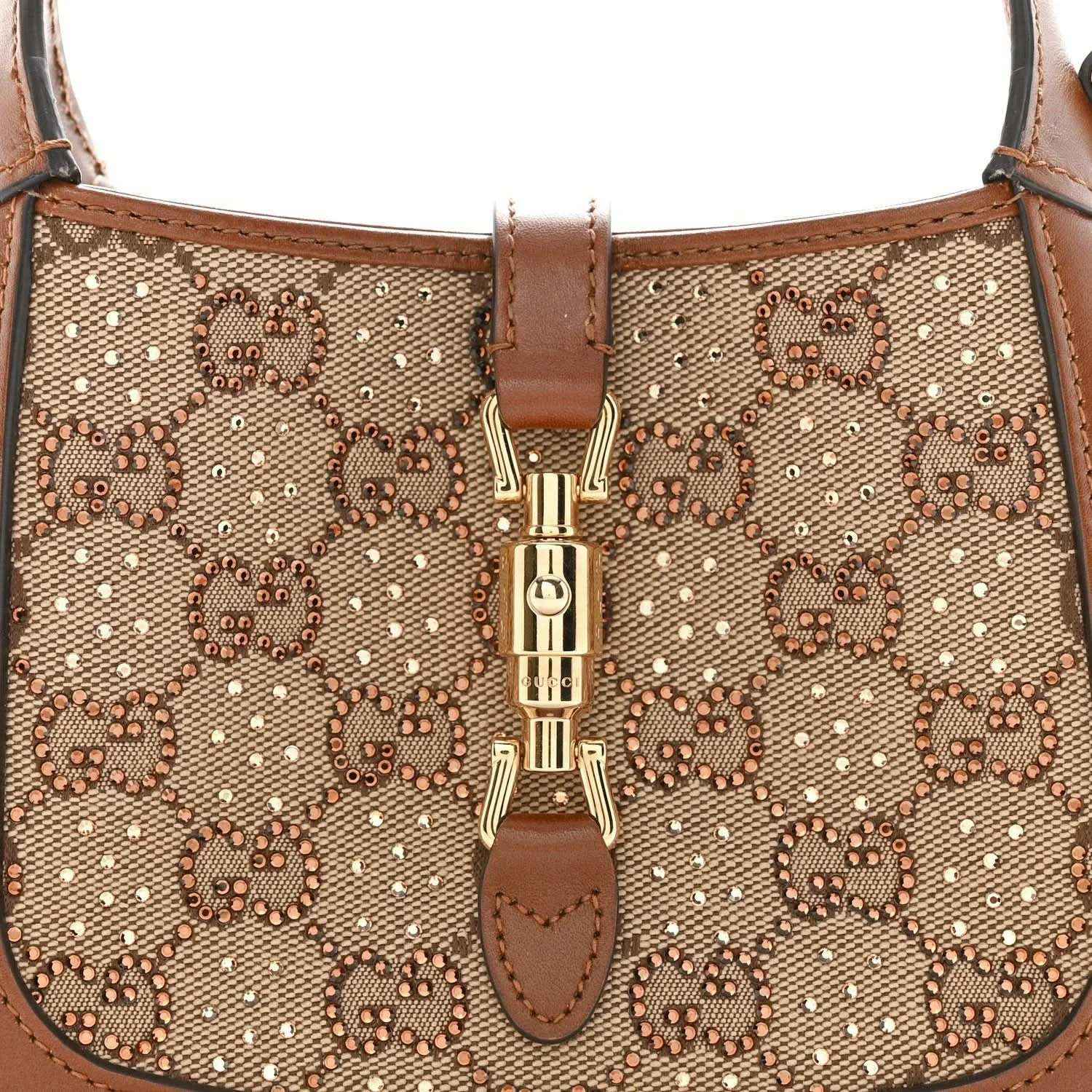 Mini hobo bag front close-up, beige GG monogram canvas with gold-toned clasp detail