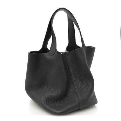 Dark gray leather tote bag with structured sides, top handles, and center front seam