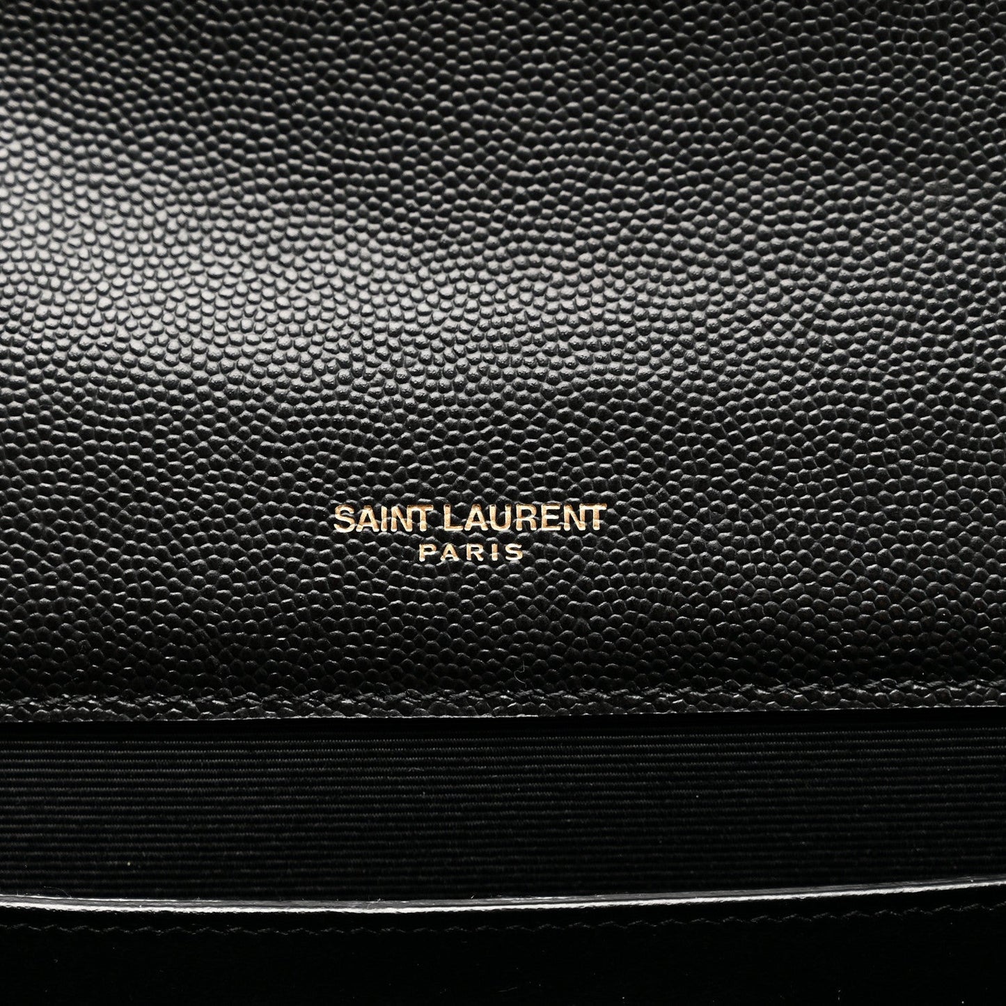 Black embossed satchel panel with centered Saint Laurent Paris logo