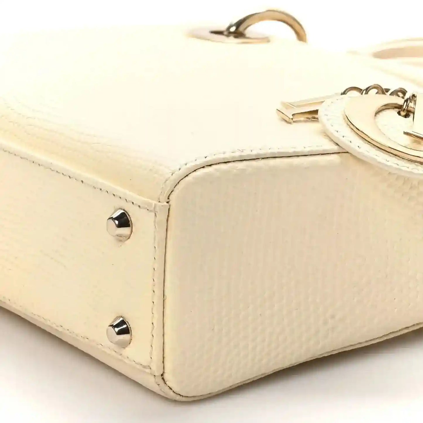 Ivory lizard mini handbag corner with gold studs and top handle base