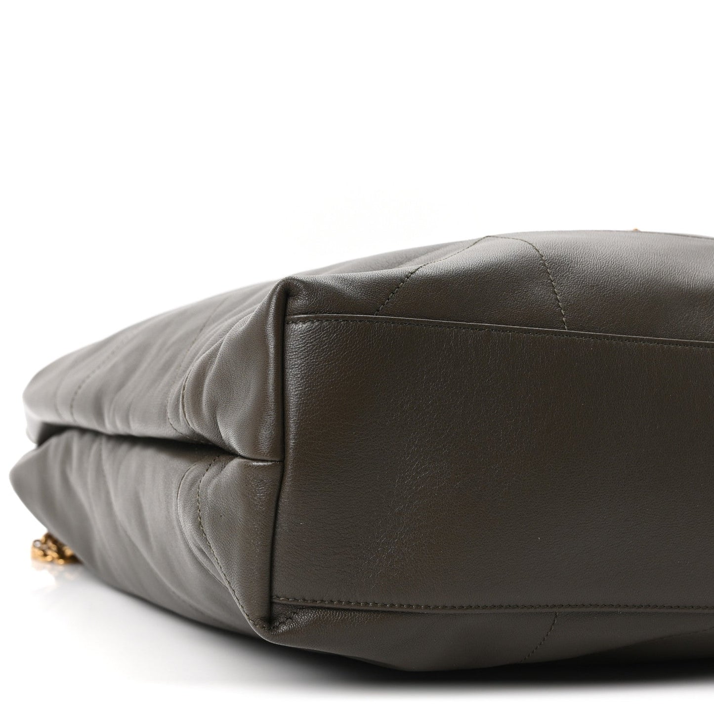 Quilted leather shoulder bag bottom corner detail with gold hardware
