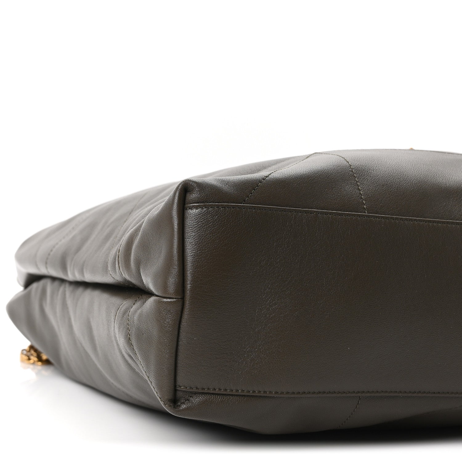Quilted leather shoulder bag bottom corner detail with gold hardware