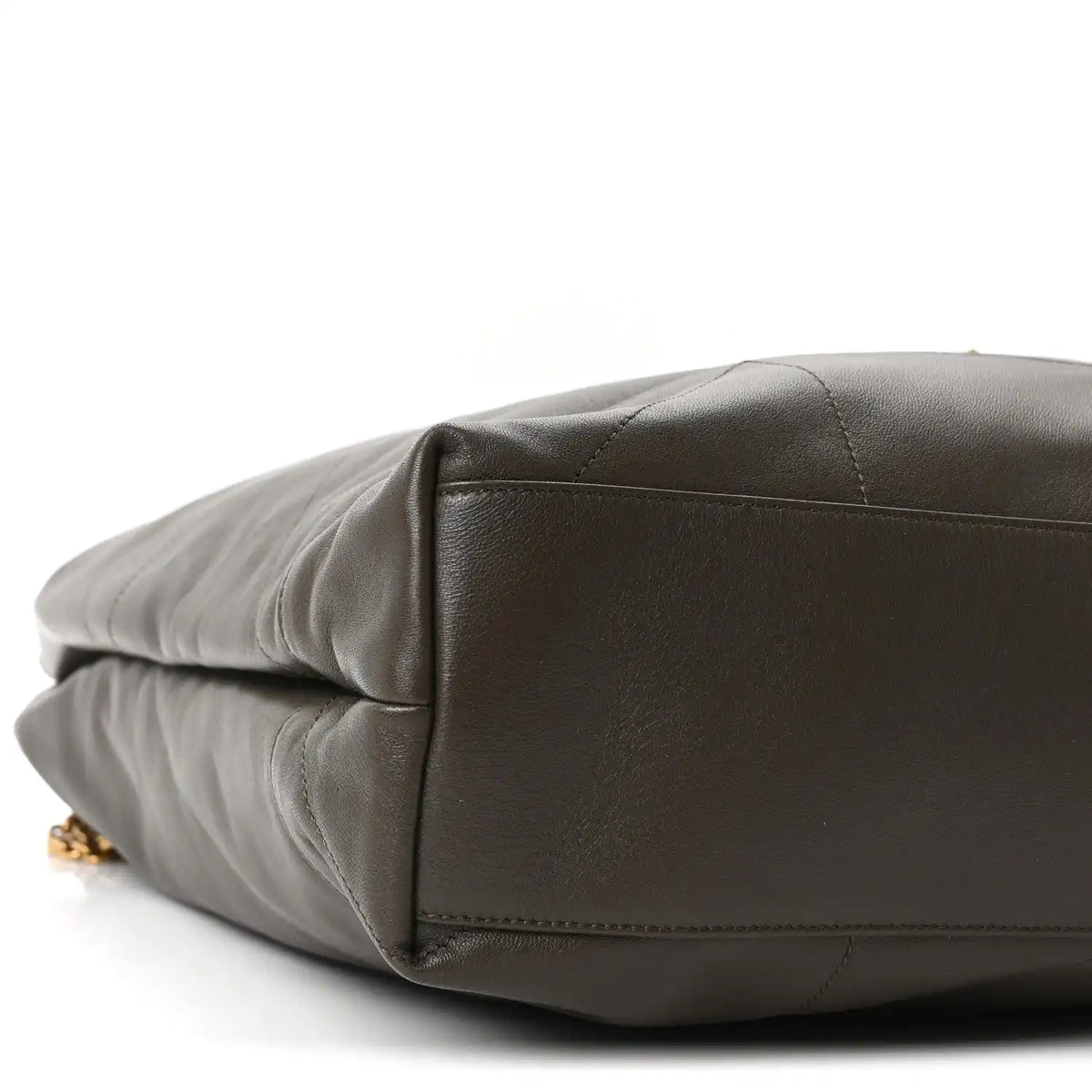Quilted leather shoulder bag bottom corner detail with gold hardware