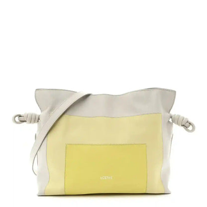 Knot clutch in pale grey leather with light citrine front panel and braided cord handles