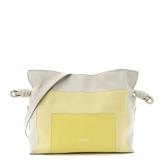 Knot clutch in pale grey leather with light citrine front panel and braided cord handles