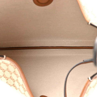 Leather-lined interior panel of brown shoulder bag with visible stitched trim