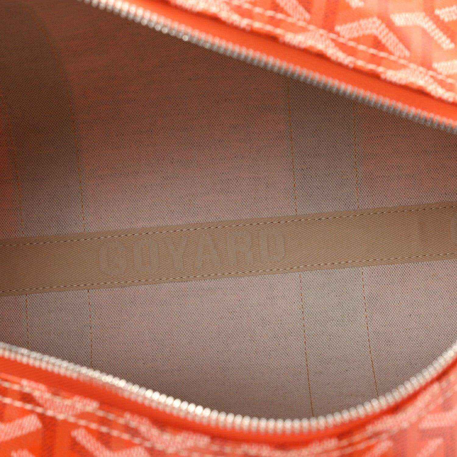 Inside view of orange canvas sports bag with lining, zipper, and seam stitching.