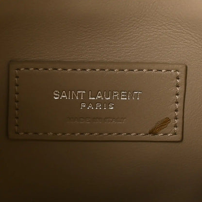 Saint Laurent Paris leather brand label with stitching on a beige bag