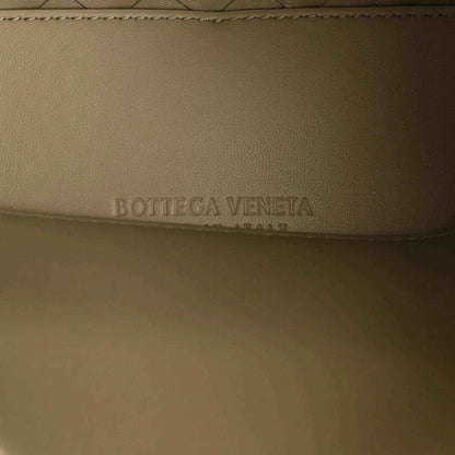 Bottega Veneta logo embossed on travertine-tone leather lining of small shoulder bag