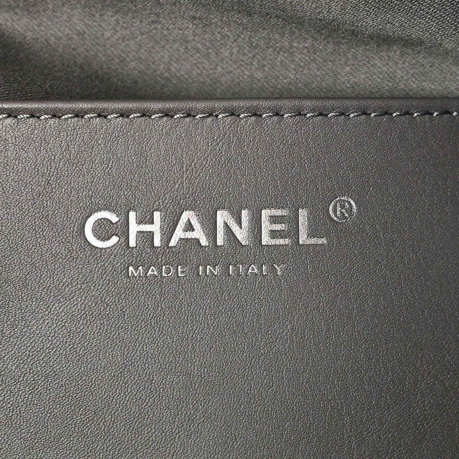 Chanel logo patch reading CHANEL and MADE IN ITALY on dark leather