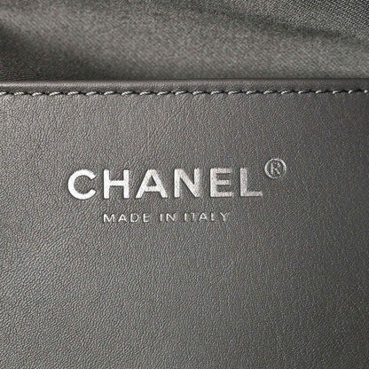 Chanel logo patch reading CHANEL and MADE IN ITALY on dark leather