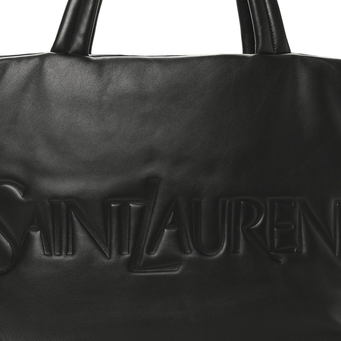 Black SAINT LAURENT embossed logo on lambskin wide puffer tote front panel.