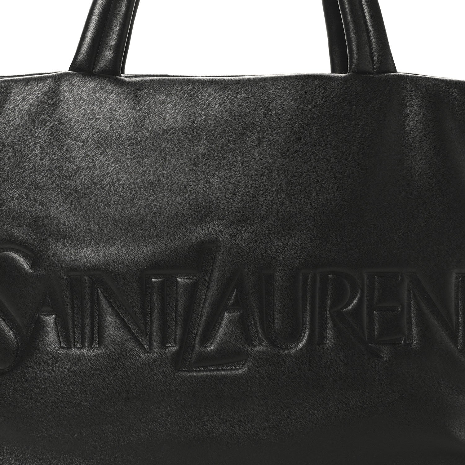 Black SAINT LAURENT embossed logo on lambskin wide puffer tote front panel.