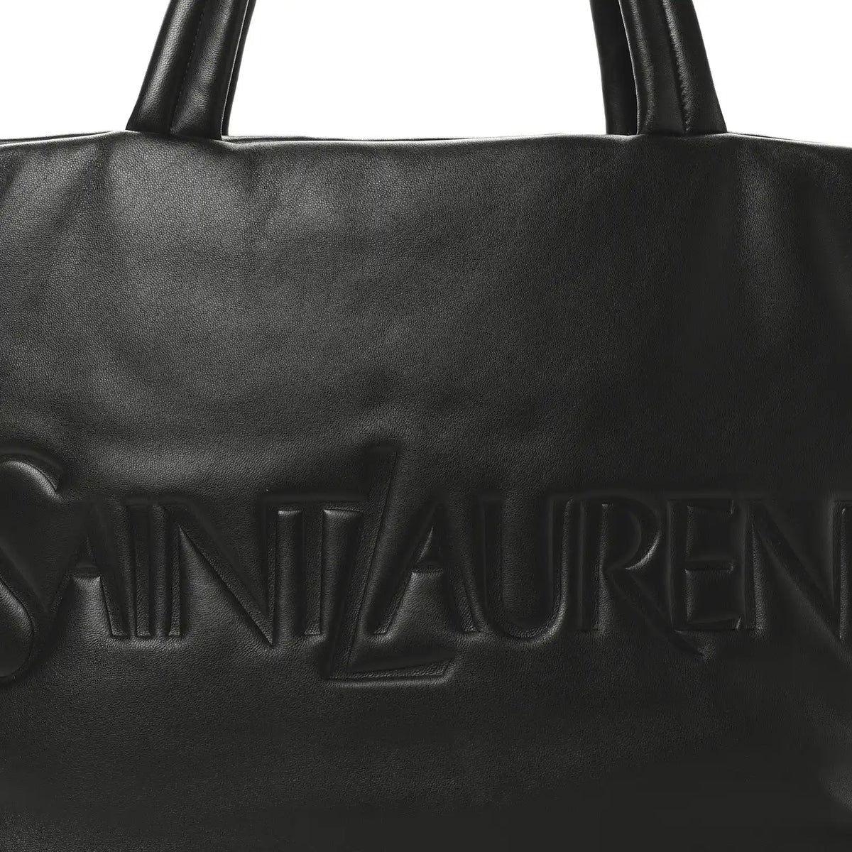Black SAINT LAURENT embossed logo on lambskin wide puffer tote front panel.
