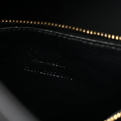 Black leather hobo bag interior detail with gold chain edging and stitching