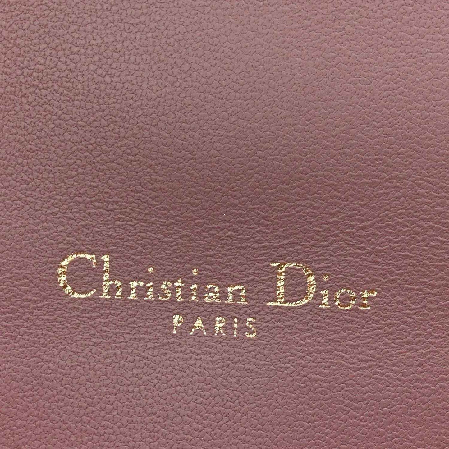 Purple leather with “Christian Dior Paris” embossed text