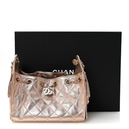 Copper metallic quilted mini handbag with chain strap and Chanel CC front logo.