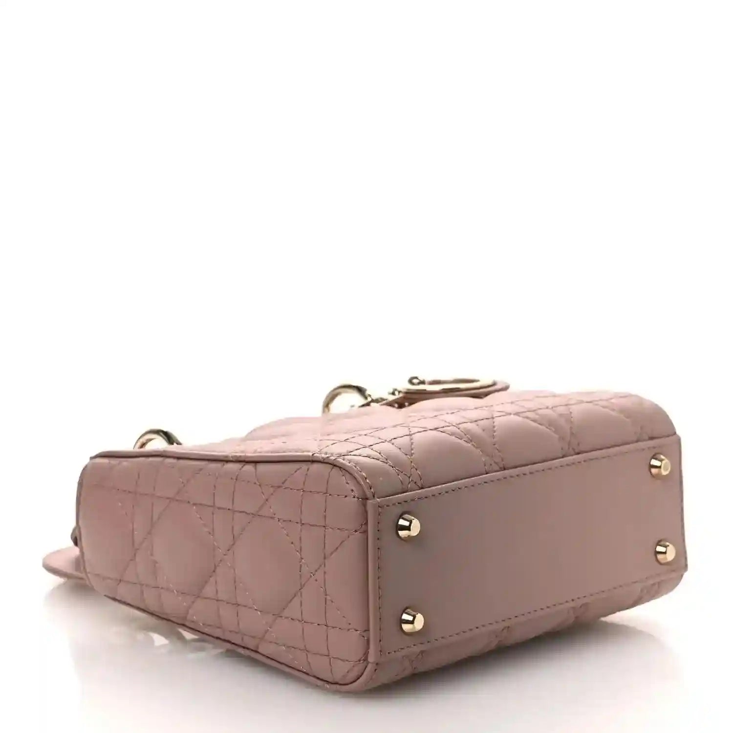 Mini Lady Dior handbag back view in pink leather with gold studs and short top handle.