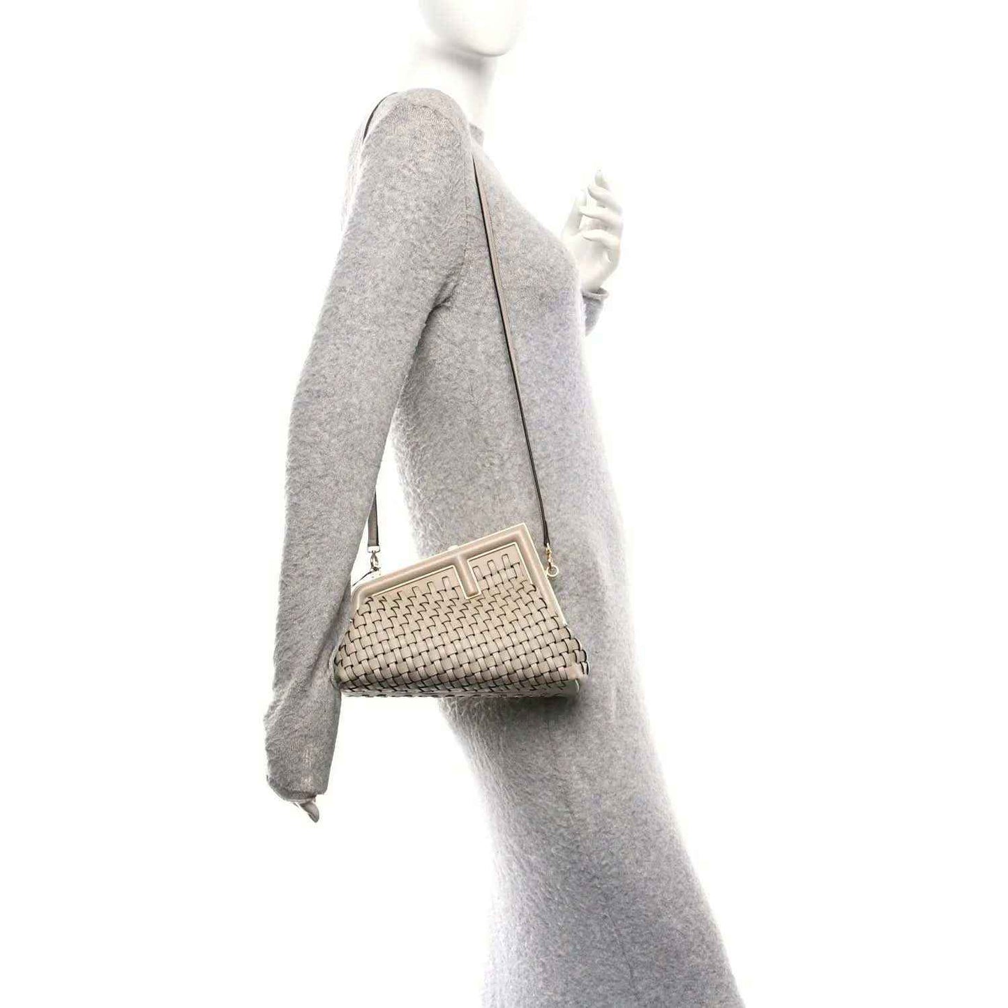 Ivory woven leather clutch crossbody bag worn with an adjustable shoulder strap