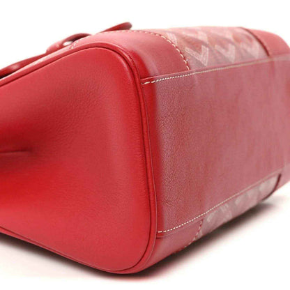 Red mini handbag with smooth leather side and coated canvas panel, stitched seams.