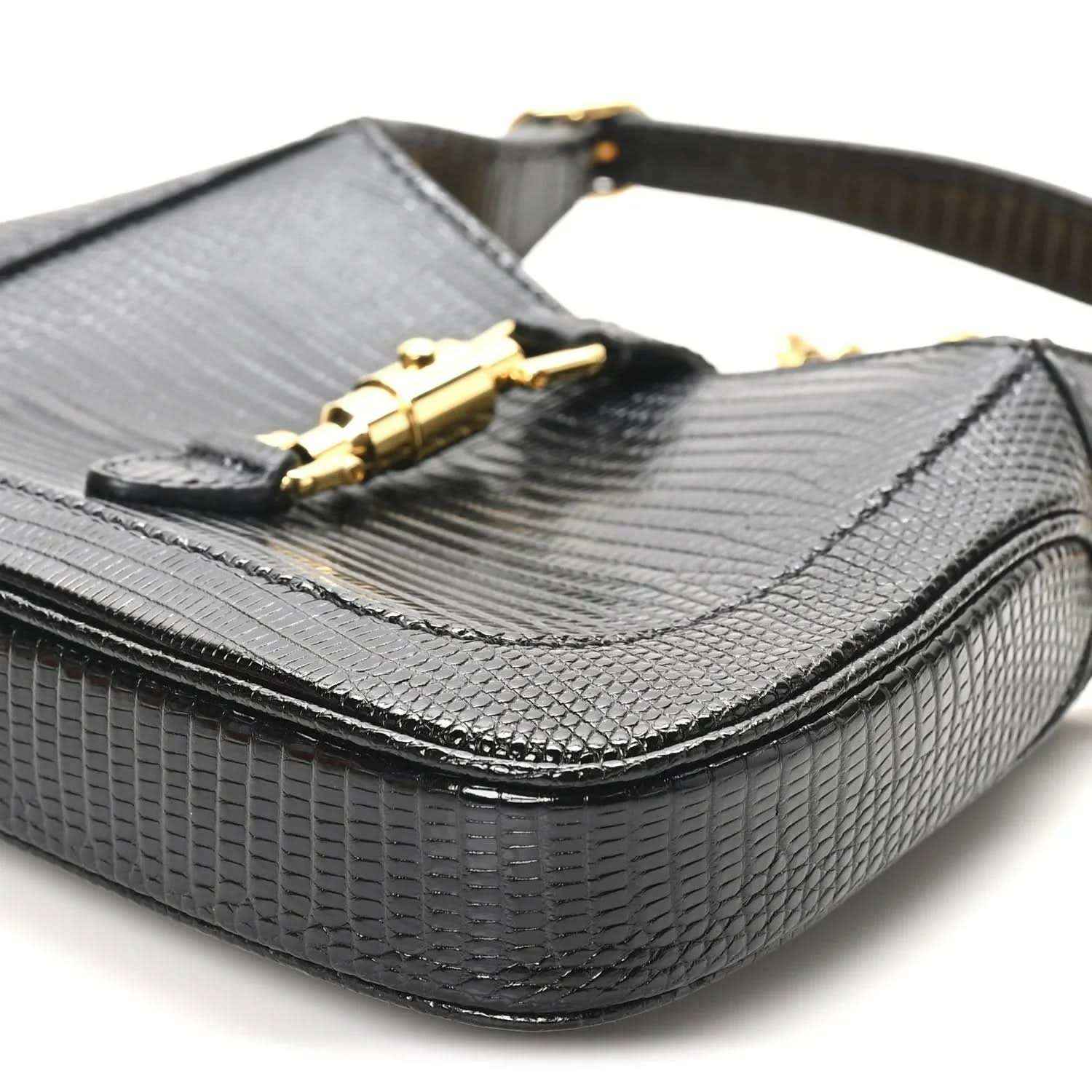 Black lizard mini Jackie handbag with front flap and gold-tone clasp hardware on top.