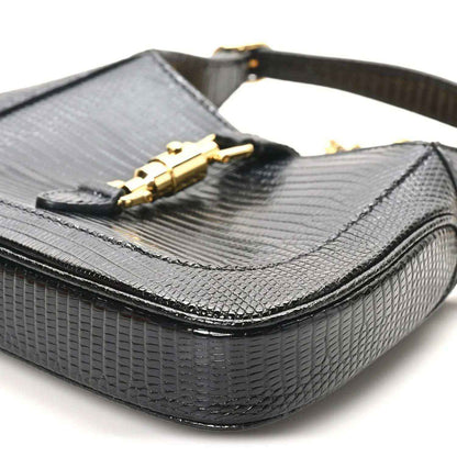 Black lizard mini Jackie handbag with front flap and gold-tone clasp hardware on top.