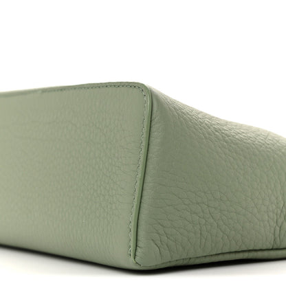 Sage green grained calfskin pouch side panel with edge stitching, close-up