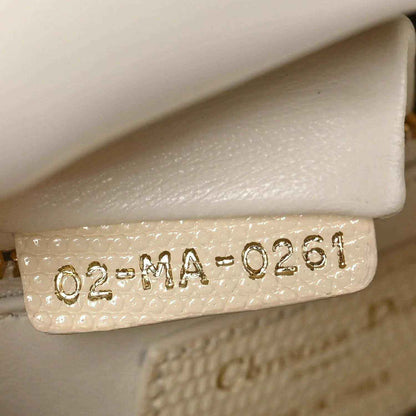 Ivory lizard mini handbag with stamped authenticity date code on leather