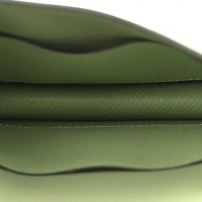 Light green leather wallet interior close-up with curved seam
